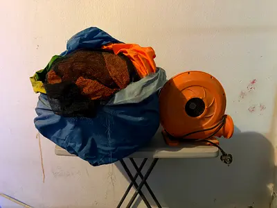 Electric air blower with deflated inflatable castle play item (used)