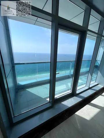 Exceptional Dual Level Coastal Residence Offering Unmatched Panoramic Vistas of the Shimmering Sea and the Vibrant City Skyline Within the Prestigious