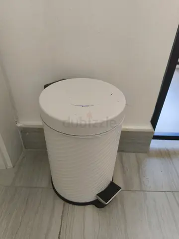 Small white pedal trash bin.