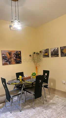 4-Seater Glass Dining Table with Modern Black Chairs - Good Condition with a carpet and all the deco
