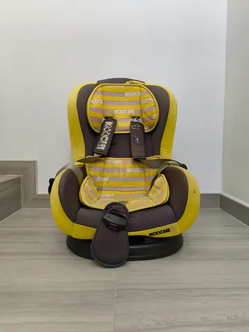 Used yellow and brown Koochi car seat