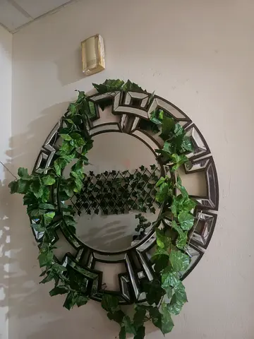 Round decorative wall mirror with geometric frame (good condition)