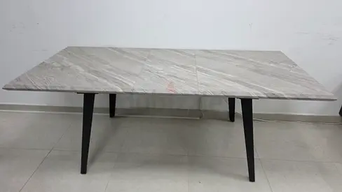 Extendable modern dining table with faux marble top and black legs
