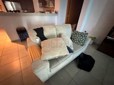 Two-seater beige fabric loveseat in good used condition
