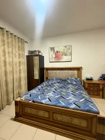 Solid wood queen size bed with mattress and matching nightstands