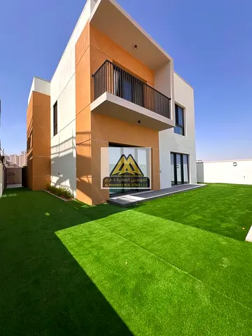 Villa for rent in Al Amerah, Ajman, with 4 bedrooms, maid’s room, and 2 parking spaces. Located in a fully serviced community with a swimming pool, gy