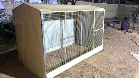 Large outdoor metal dog cage with protective cover