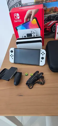 White Nintendo Switch OLED console with dock, accessories and protective case