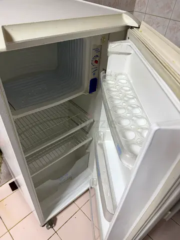 Small upright freezer with removable shelves and ice tray - good working condition