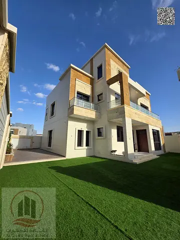Villa for sale in Ajman, Al Zahia area, including registration. 6 master bedrooms, majlis, living room, and maid's room. Freehold ownership for all na