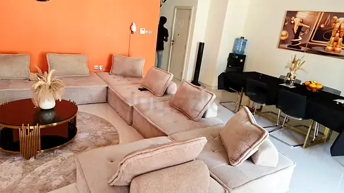 Large L-shaped beige fabric sofa set with coffee table — well maintained