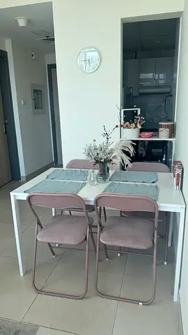 White dining table with 4 pink folding chairs - compact set