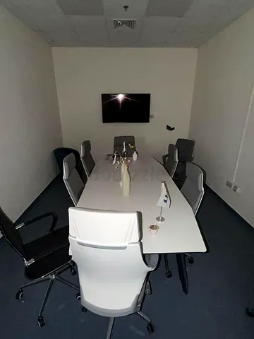Meeting room table with 8 ergonomic office chairs and wall TV - very good condition
