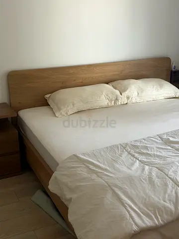 Wooden double bed frame with headboard and mattress