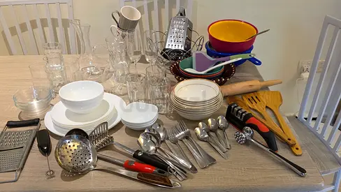 Mixed kitchenware set - plates, bowls, utensils, and cookware (used)
