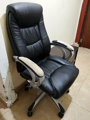 Used black leather swivel office chair with armrests