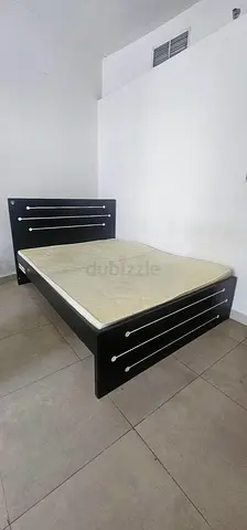 Single black wooden bed frame with mattress - good condition