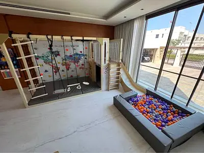 Moonkid customize tree house with a monkey bars frame ,slide,climbing wall and ball pit.