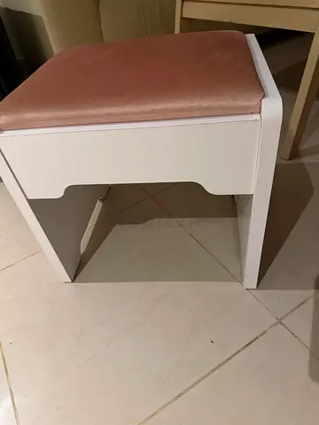 Small white wooden vanity stool with pink cushion make up