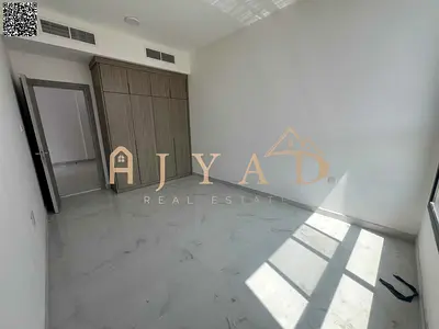 First-tenant 1BR apartment with hall in Al Alia, Ajman. Free month, master bedroom, 2 baths, balcony, central AC, wardrobes, easy payments.