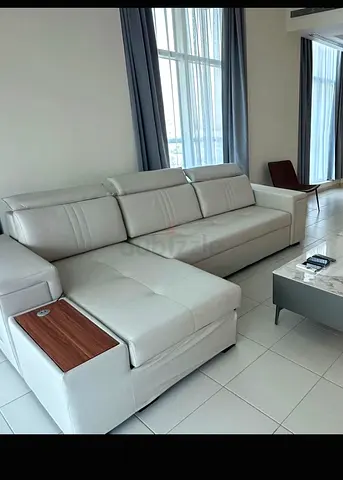Light grey L-shaped leather sofa with chaise