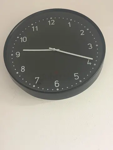 IKEA black wall clock - battery operated, working without click sound.Perfect inside and out.