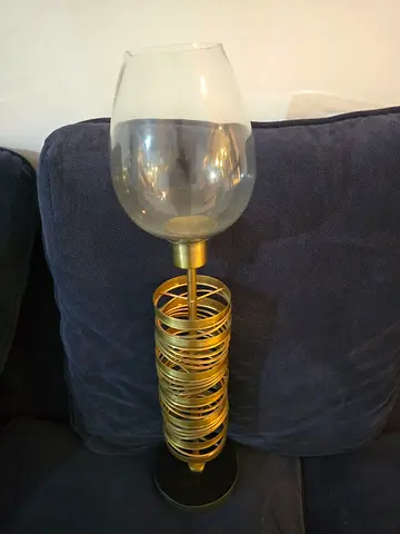 Tall decorative floor lamp with glass shade and gold spiral base
