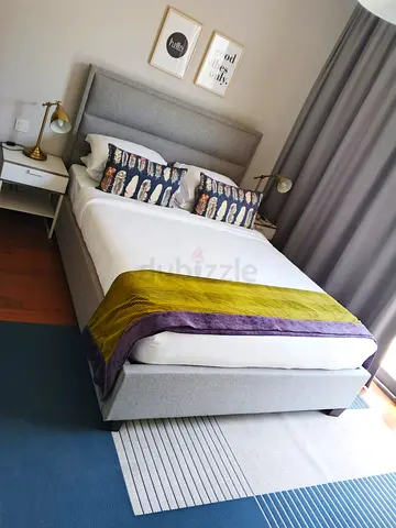 Grey upholstered double bed with headboard and storage base with mattress - good condition