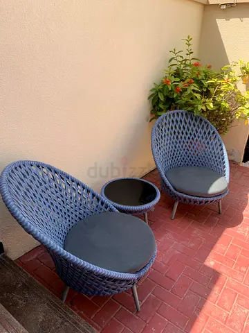 Pair of outdoor woven lounge chairs with small side table - good condition