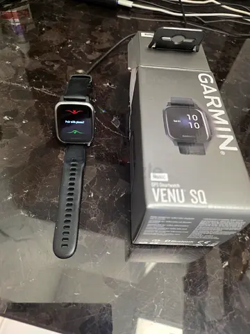Garmin Venu Sq smartwatch with original box and charger — good condition