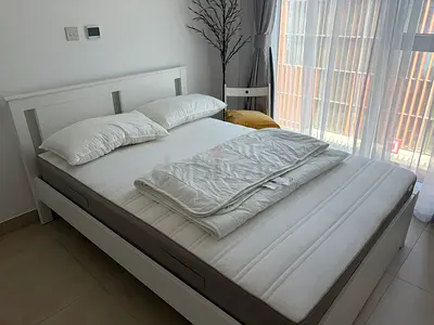 IKEA Songesand White Wooden Double Bed Frame with Mattress and thin bedding plus two pillows.