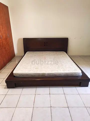 Wooden bed with mattress