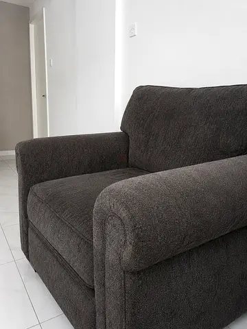 Dark green fabric single seater sofa in excellent condition