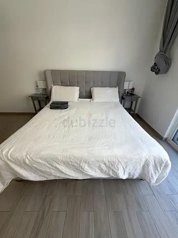 Queen upholstered bed with padded headboard - good condition