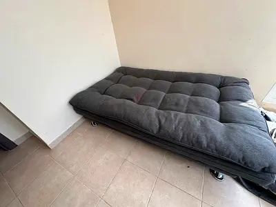 Grey foldable futon sofa bed on wheels - excellent condition