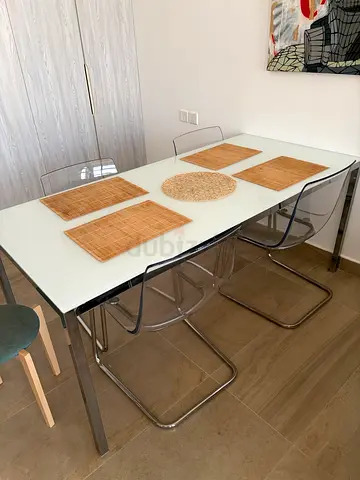 Glass table with plastic chairs