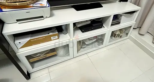 White low TV console / storage unit with glass-front cabinets — good condition