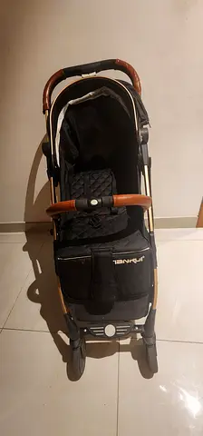 Lightweight baby stroller with leatherette handle and footrest — good condition
