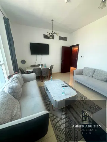 Two furnished bedrooms, including a master bedroom, large living room, equipped kitchen, two bathrooms, balcony with open views, storage room, parking