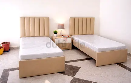 Pair of single beds with upholstered headboards and storage bases - used