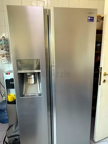 Used large stainless steel side-by-side refrigerator with water dispenser
