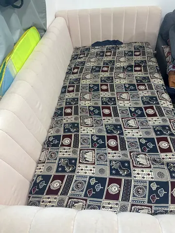 Light beige convertible sofa bed with patterned mattress topper - (7000 new)