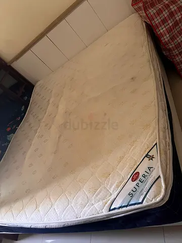 Used king size  Mattress and bed frame . Superia brand, minor stains, good support