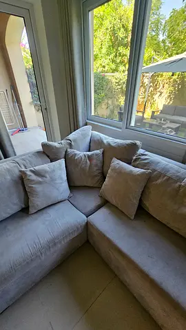 Light grey L-shaped sectional sofa with cushions - good condition