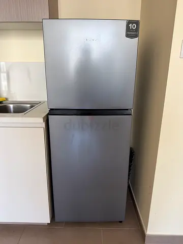 Hi-sense, silver two-door refrigerator in great condition. 1 year old