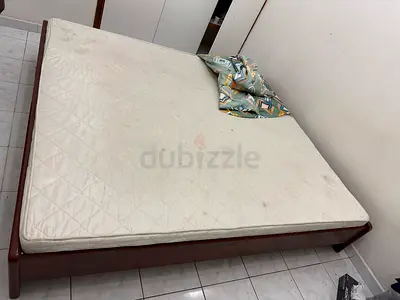 Used double bed frame with mattress — simple wooden frame