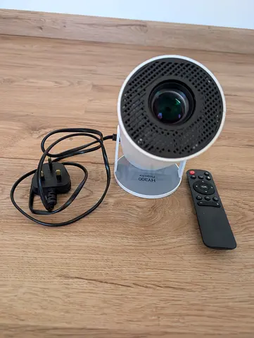 portable white LCD projector, likely a model similar to the HY300 or X10