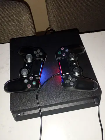 PlayStation 4 Slim with 2 DualShock Controllers - Good Working Condition.