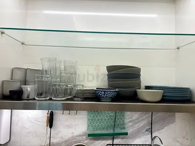 Used set of everyday bowls, plates and glassware - neutral grey/blue
