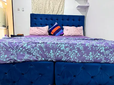 Blue tufted queen bed frame with headboard
